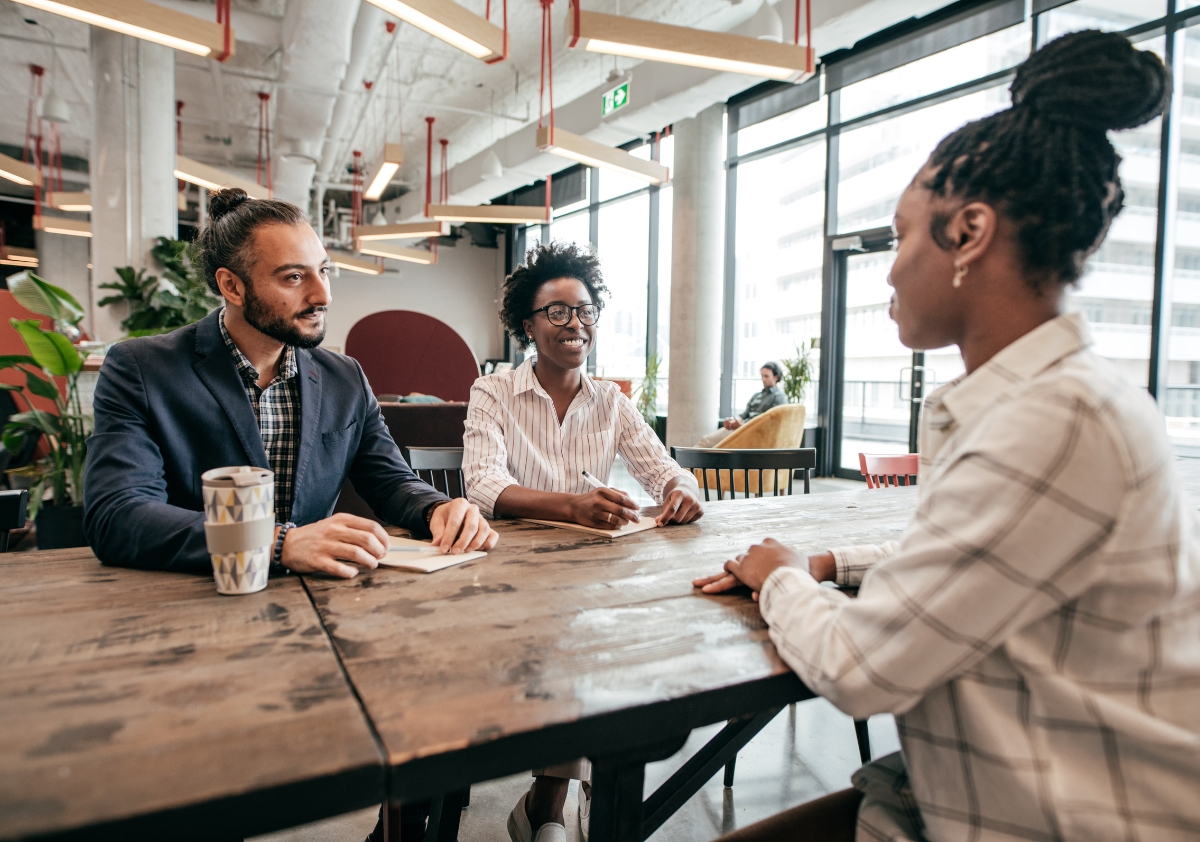 A multicultural hiring team implement diversity hiring when considering a Black professional female