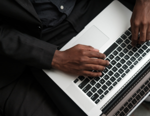 Hands typing on a laptop