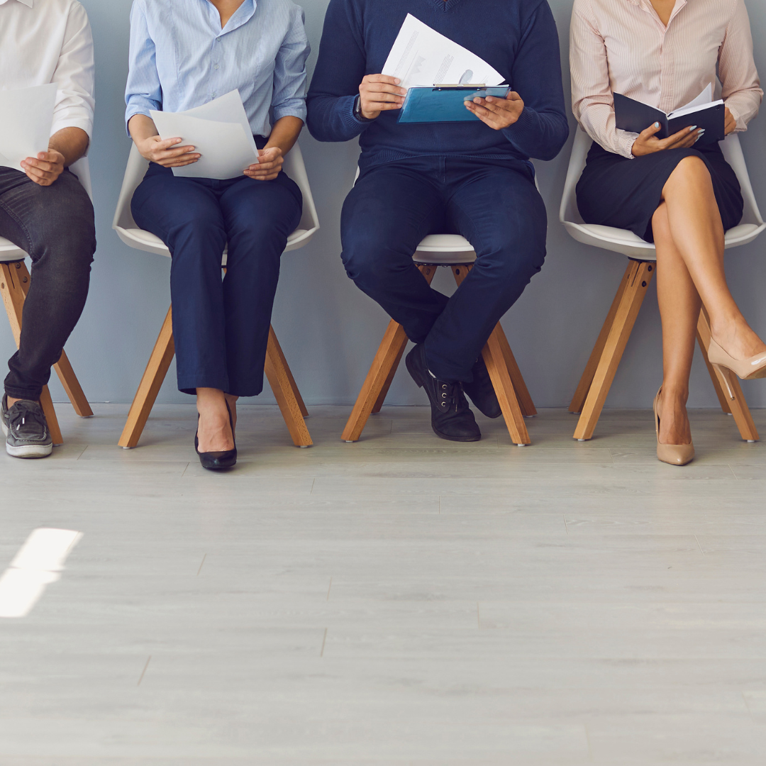 Candidates waiting to interview for a job with faces not shown