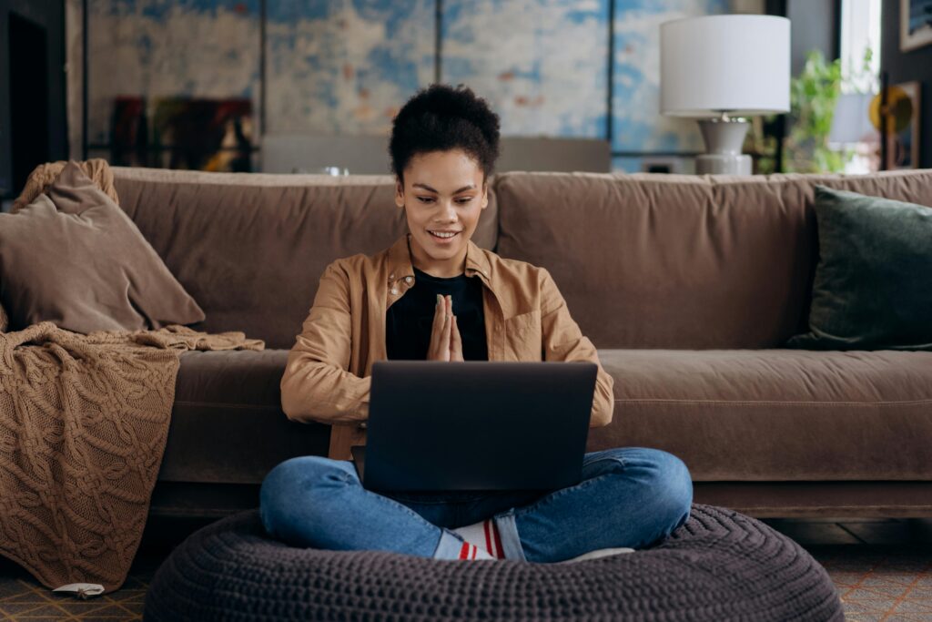 Best way to email recruiter. Woman sitting on the floor with a laptop on her lap.